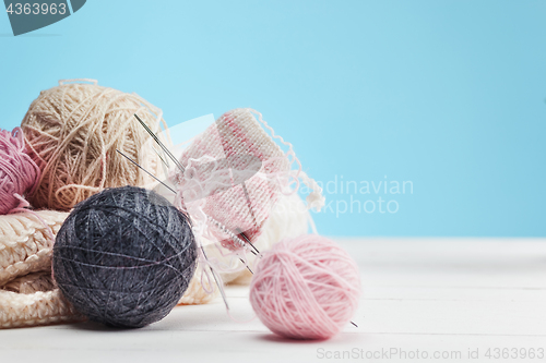 Image of The balls of wool on white wooden background