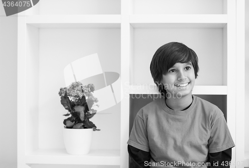 Image of young boy posing on a shelf