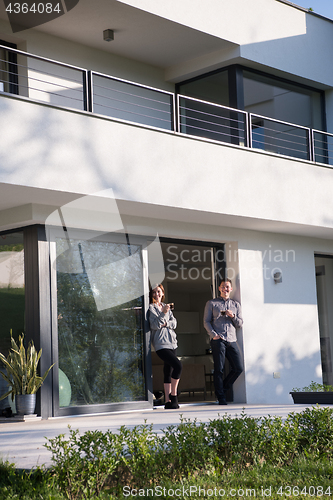 Image of couple enjoying on the door of their luxury home villa