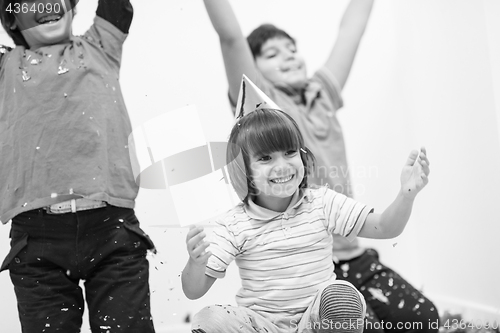 Image of kids  blowing confetti