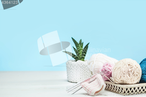 Image of The balls of wool on white wooden background