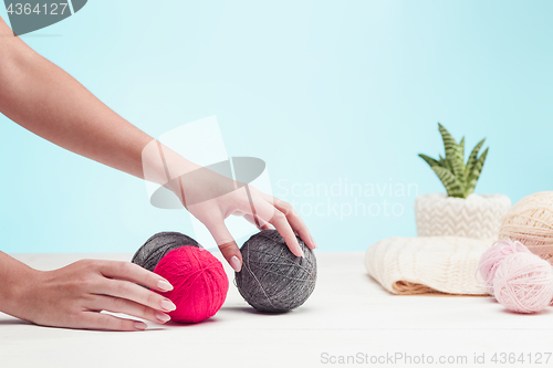 Image of The balls of wool on white wooden background