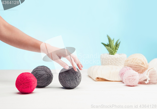 Image of The balls of wool on white wooden background