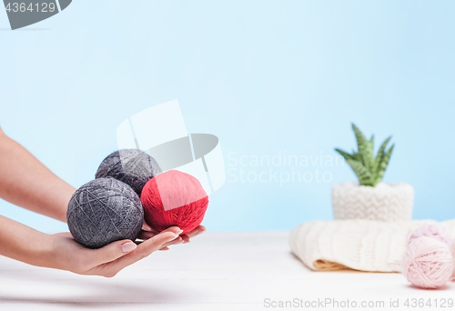 Image of The balls of wool on white wooden background