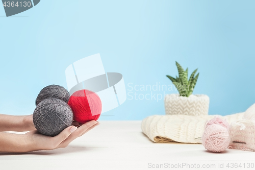 Image of The balls of wool on white wooden background