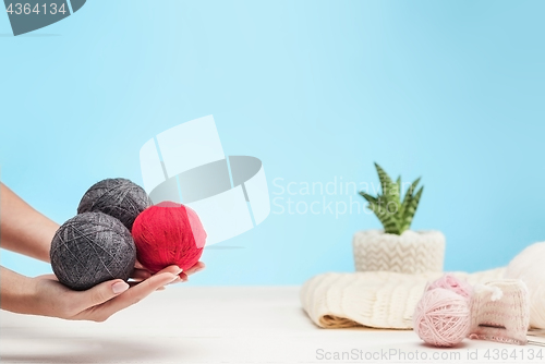 Image of The balls of wool on white wooden background