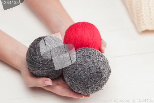 Image of The balls of wool on white wooden background