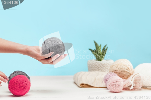 Image of The balls of wool on white wooden background