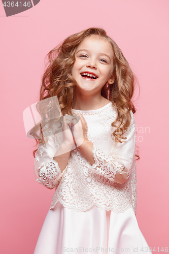 Image of The beautiful little girl in dress standing and posing over white background