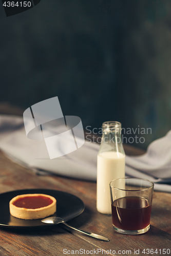 Image of Opened craft paper envelope , autumn leaves and coffee on wooden table