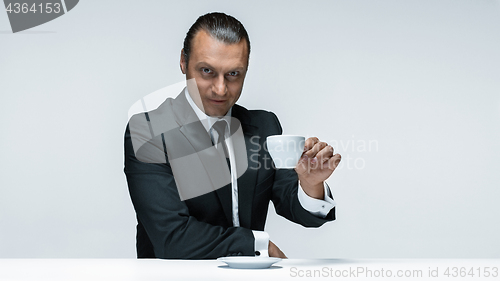 Image of The attractive man in black suit on white background