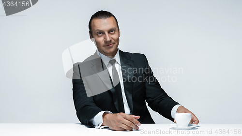 Image of The attractive man in black suit on white background