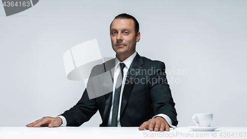 Image of The attractive man in black suit on white background