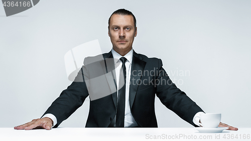 Image of The attractive man in black suit on white background