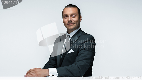 Image of The attractive man in black suit on white background