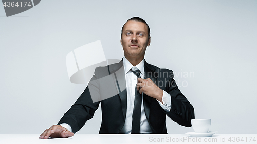 Image of The attractive man in black suit on white background