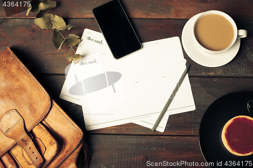 Image of Opened craft paper envelope , autumn leaves and coffee on wooden table