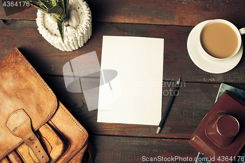 Image of Opened craft paper envelope , autumn leaves and coffee on wooden table