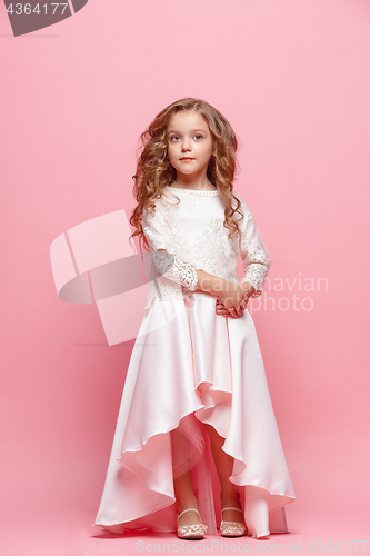 Image of Full length of beautiful little girl in dress standing and posing over white background