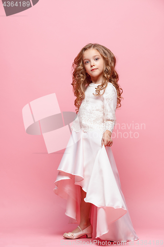 Image of Full length of beautiful little girl in dress standing and posing over white background