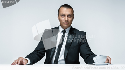 Image of The attractive man in black suit on white background