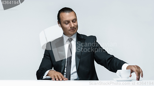 Image of The attractive man in black suit on white background