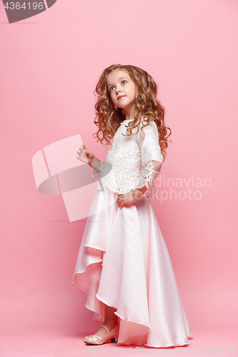 Image of Full length of beautiful little girl in dress standing and posing over white background