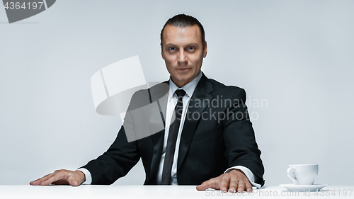 Image of The attractive man in black suit on white background