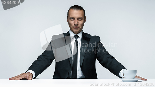 Image of The attractive man in black suit on white background