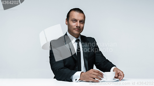 Image of The attractive man in black suit on white background