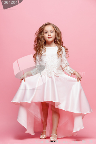 Image of Full length of beautiful little girl in dress standing and posing over white background