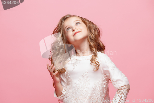 Image of The beautiful little girl in dress standing and posing over white background