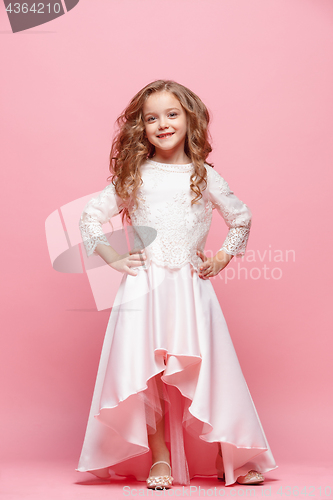 Image of Full length of beautiful little girl in dress standing and posing over white background