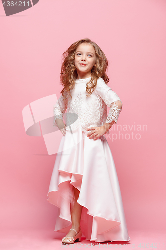 Image of Full length of beautiful little girl in dress standing and posing over white background