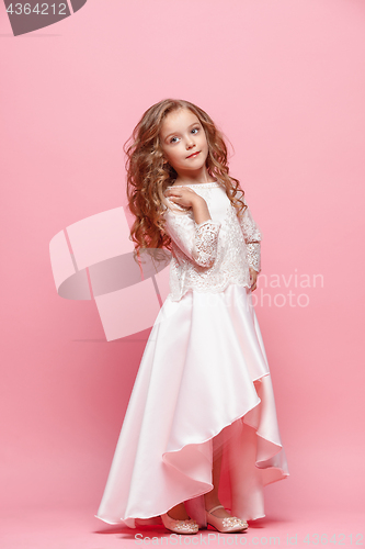 Image of Full length of beautiful little girl in dress standing and posing over white background