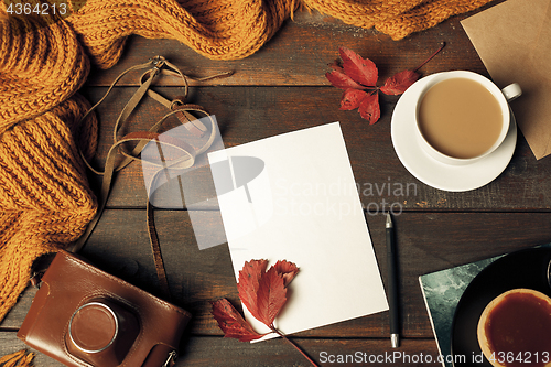 Image of Opened craft paper envelope , autumn leaves and coffee on wooden table