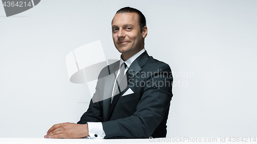 Image of The attractive man in black suit on white background