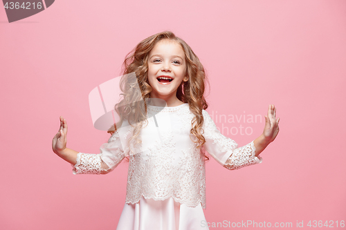 Image of The beautiful little girl in dress standing and posing over white background