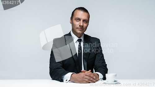 Image of The attractive man in black suit on white background