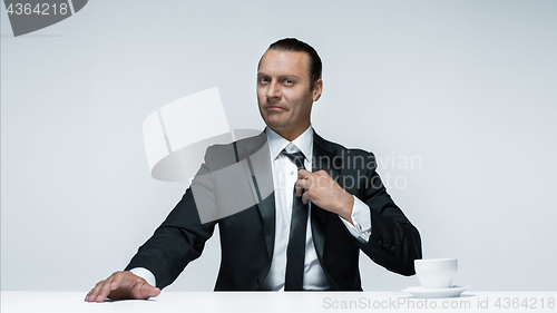 Image of The attractive man in black suit on white background