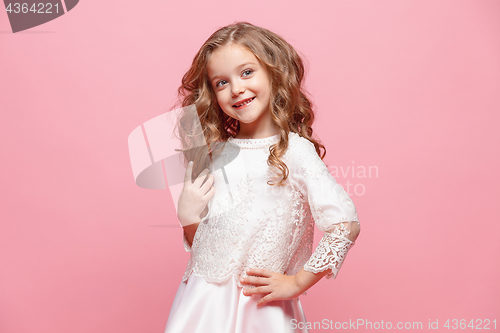 Image of The beautiful little girl in dress standing and posing over white background