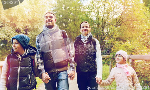 Image of happy family with backpacks hiking