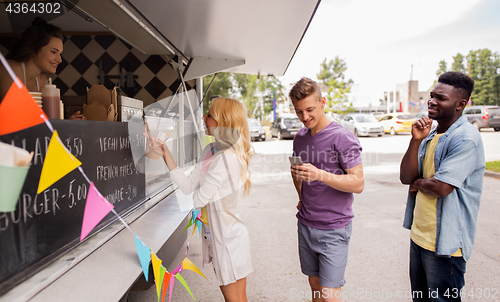 Image of happy customers queue at food truck