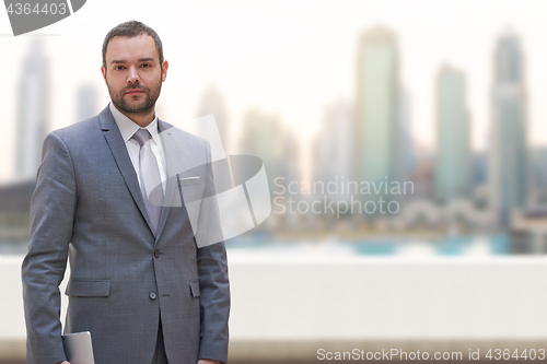 Image of Young businessman in front of the big city