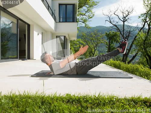 Image of man doing morning yoga exercises