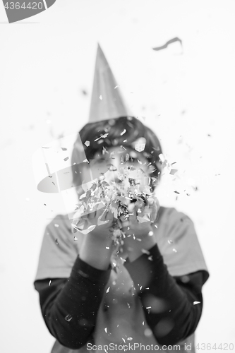 Image of kid blowing confetti