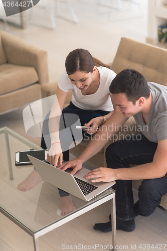 Image of happy young couple buying online