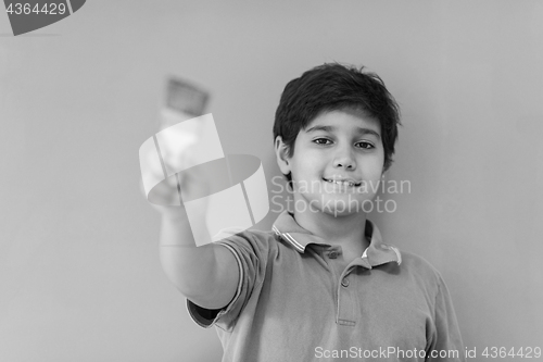 Image of Portrait of a happy young boy painter