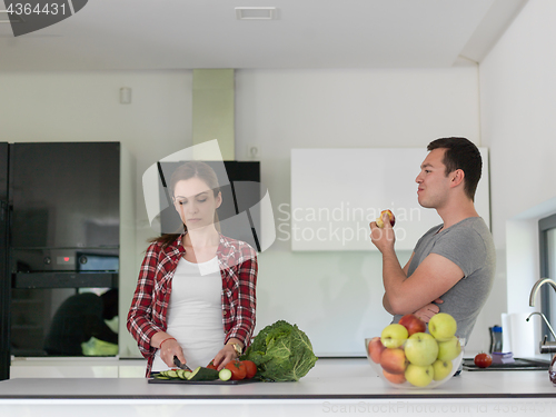 Image of Young handsome couple in the kitchen