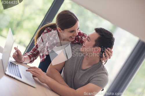 Image of happy young couple buying online